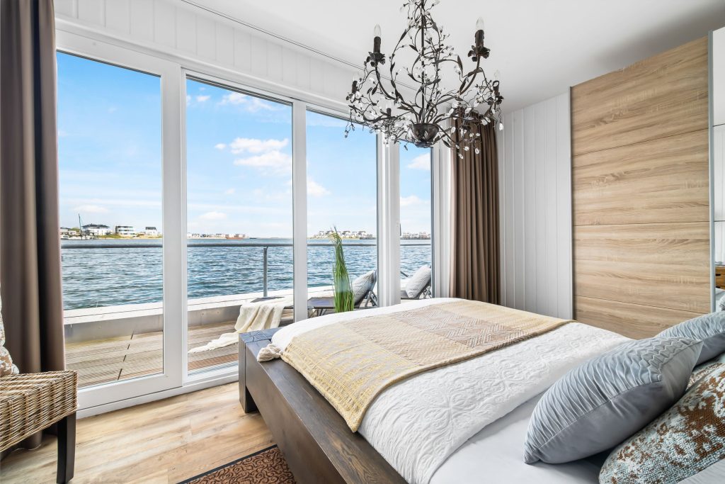Schlafzimmer mit Fensterfront mit Meerblick