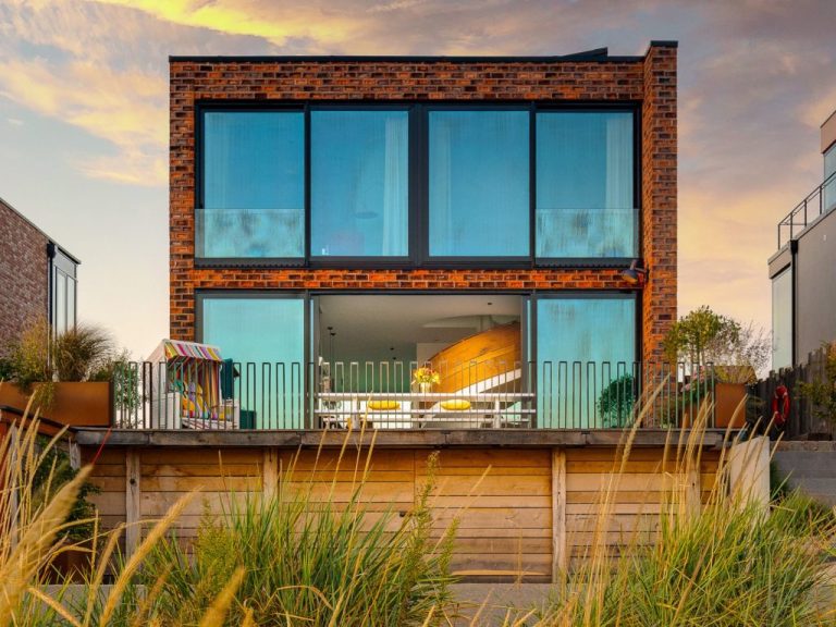 Strandvilla auf der Ostsee mit Strandgras Außenansicht buchbar bei Meerzeit für Ferien im Ostseeresort Olpenitz