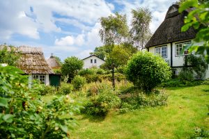 Beautiful Schlei region in Germany, Schleswig Holstein. German landscape in summer. Schlei river and typical houses with thatching, water reed roofs. Sieseby village.